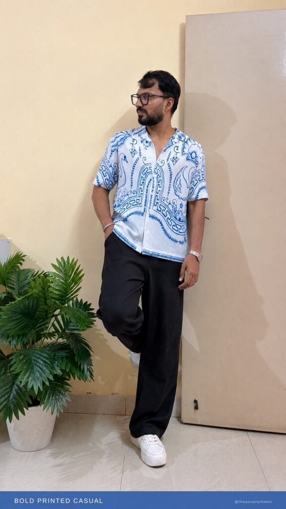 Man wearing a printed casual shirt styled for a college campus look