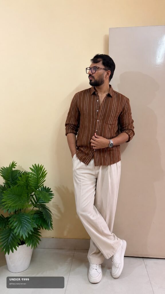 Affordable brown stripe shirt styled with cream trousers and white sneakers