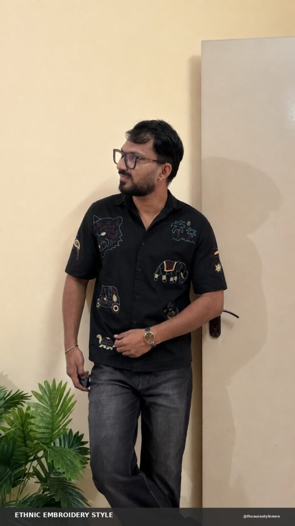 Black embroidered men’s shirt with ethnic motifs and charcoal jeans
