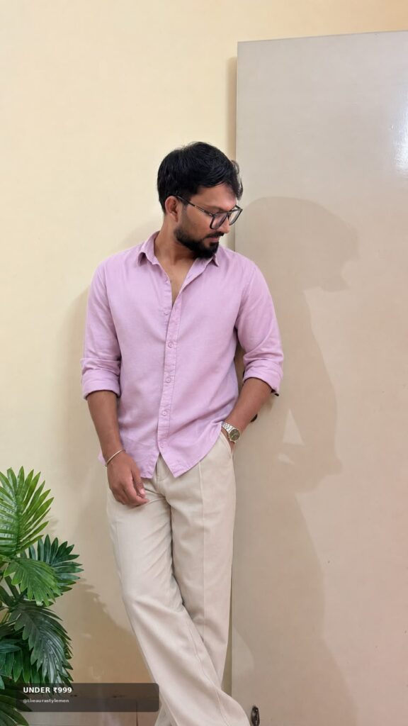 Pink solid men’s shirt styled with cream trousers and watch