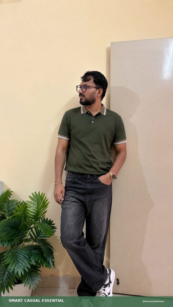 Man wearing an olive green tipped polo with charcoal jeans and white sneakers.