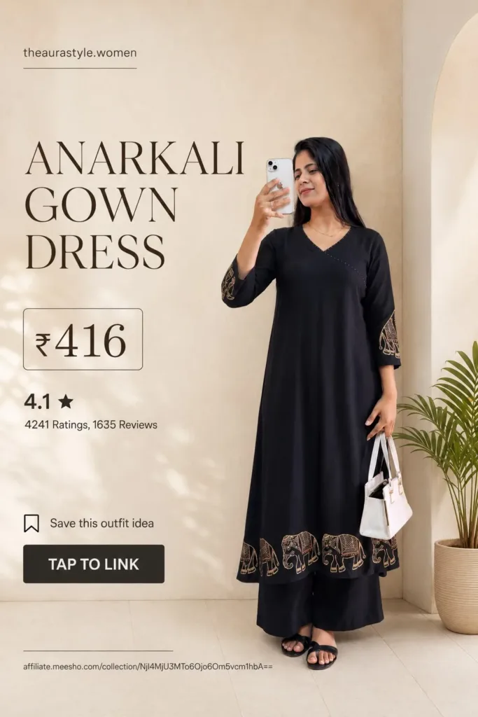 Woman wearing a black Anarkali gown dress with elephant border detailing, paired with black bottoms, sandals, and a white handbag, shown in a