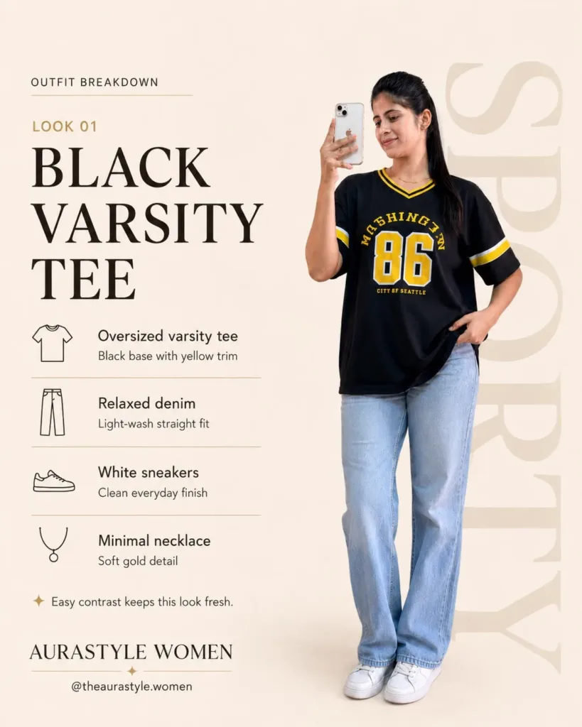 Woman in black varsity oversized tee with light blue jeans and white sneakers. — Black Varsity T-shirt Outfit for Women