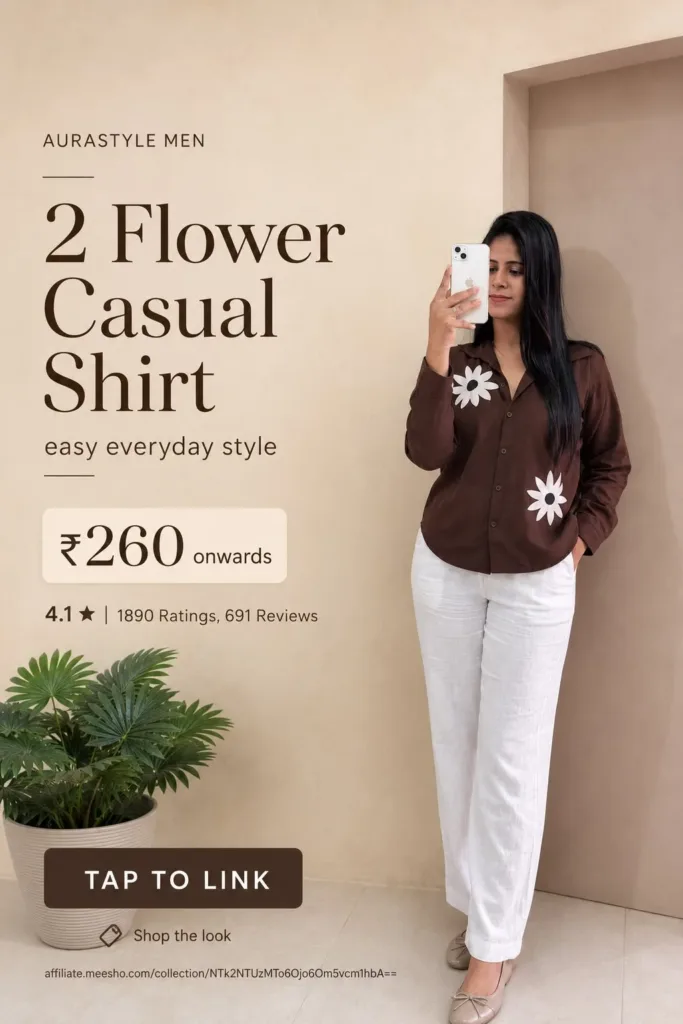 Woman wearing a brown button-down casual shirt featuring two large white floral designs, styled with white trousers and beige flats. — Brown