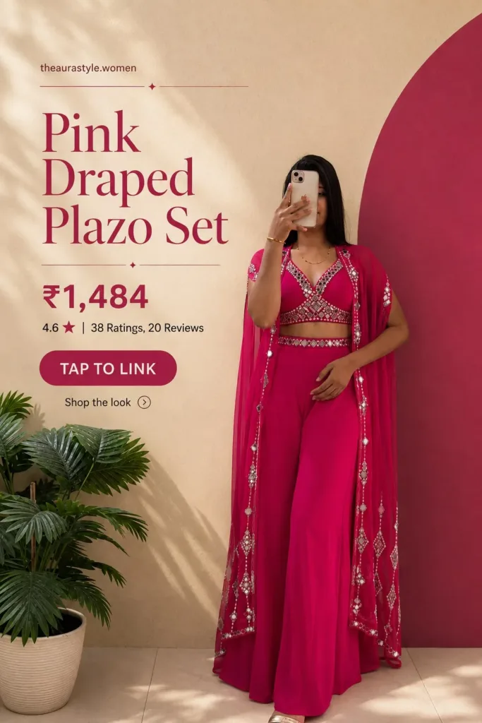 Woman wearing a bright pink draped plazo set with embellished blouse, matching flowy pants, sheer draped overlay, and gold sandals, styled in a