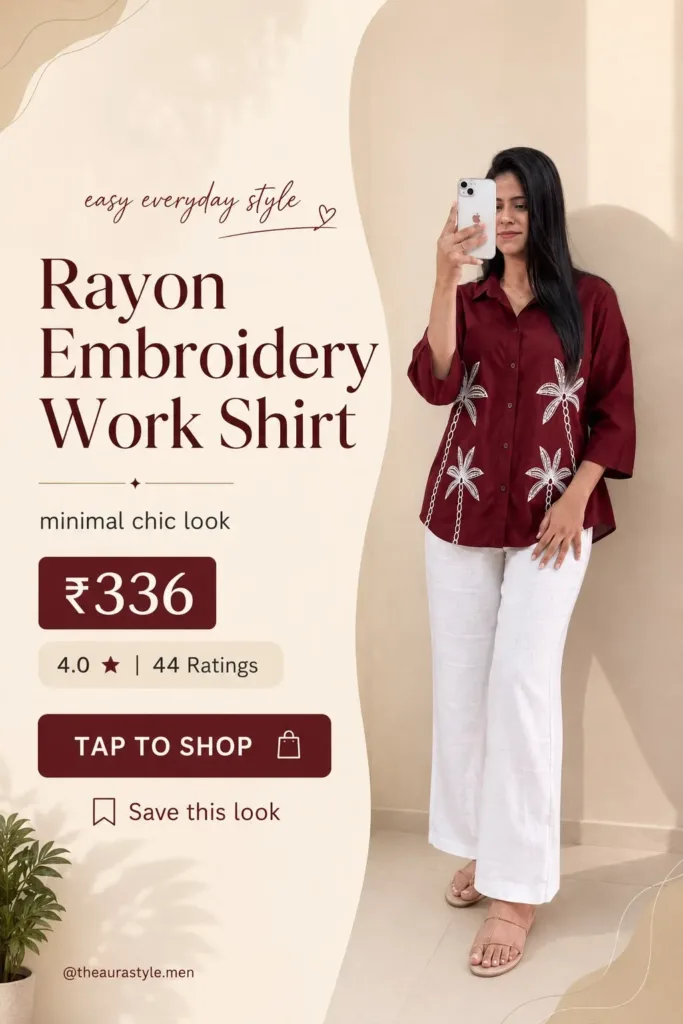 Woman wearing a maroon rayon button-down shirt with white floral embroidery, styled with white wide-leg trousers and beige sandals in a minimal