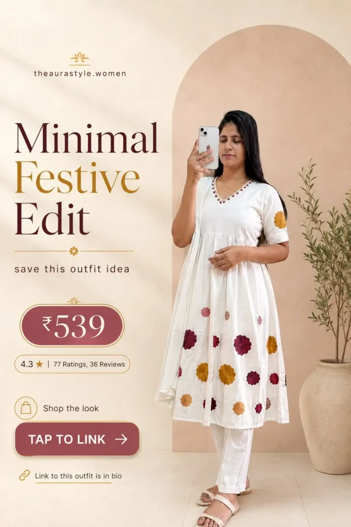 Woman wearing a white kurta and matching pants decorated with colourful floral motifs, styled with white flat sandals in a minimal indoor